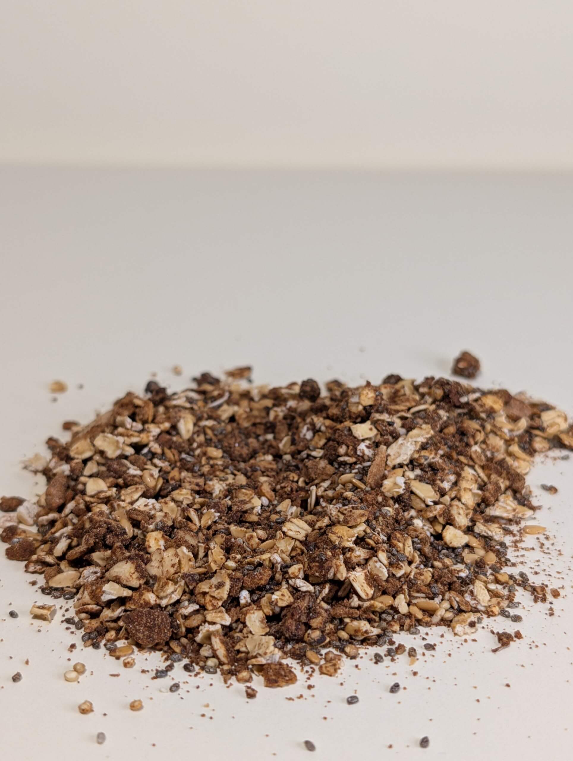 Close-up of high fibre dark chocolate protein granola with oats, seeds and chocolate clusters
